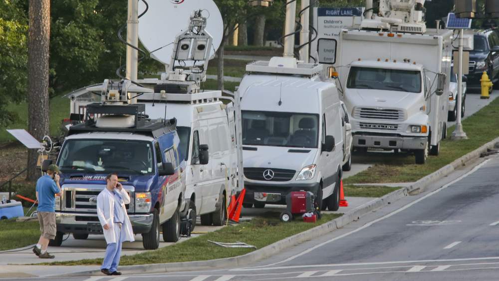 News trucks gathered, awaiting Brantly's arrival at Emory University Hospital.