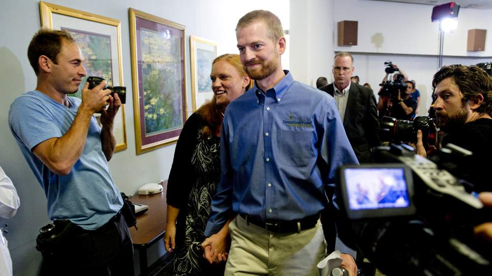Dr. Kent Brantly and his wife Amber leave a news conference after he was released from Emory University Hospital last August. Brantly contracted Ebola while working at a hospital in Liberia and became the first person with the disease in the U.S.  AP Photo/John Bazemore