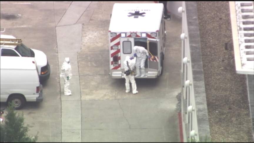 EMT Arevalo assisting Brantly on his walk into Emory Hospital. WSB-TV Channel 2