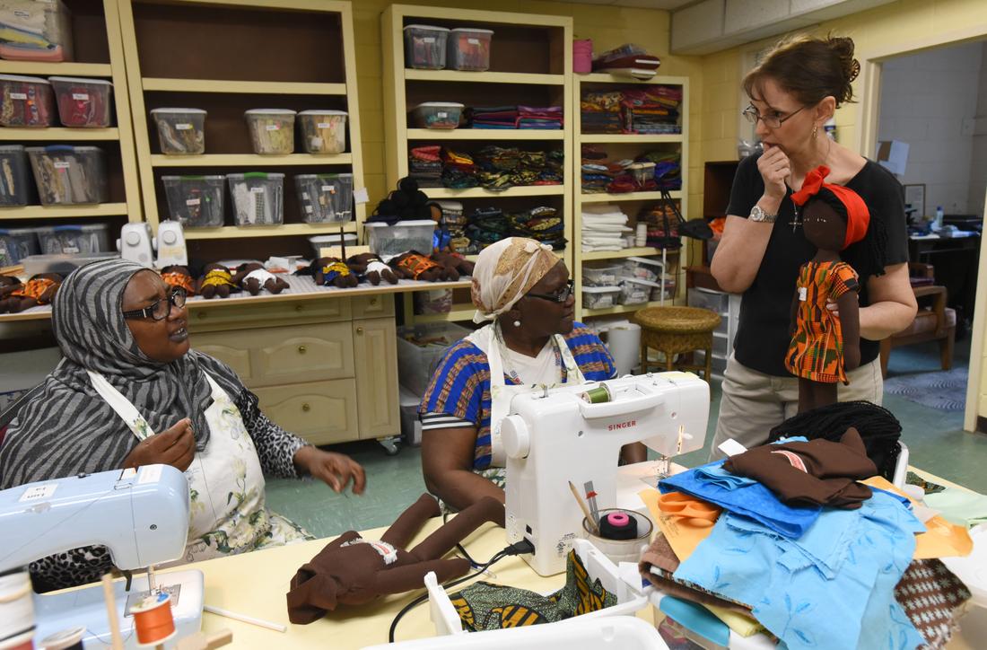 Palmer (right) consults with Alawia Abakar (left) fromSudan and Elizabeth Alier from South Sudan about the head wrap design of theRefugee Friends Doll at the Refugee Sewing Society in Clarkston.  PHOTOS BY HYOSUB SHIN / HSHIN@AJC.COM