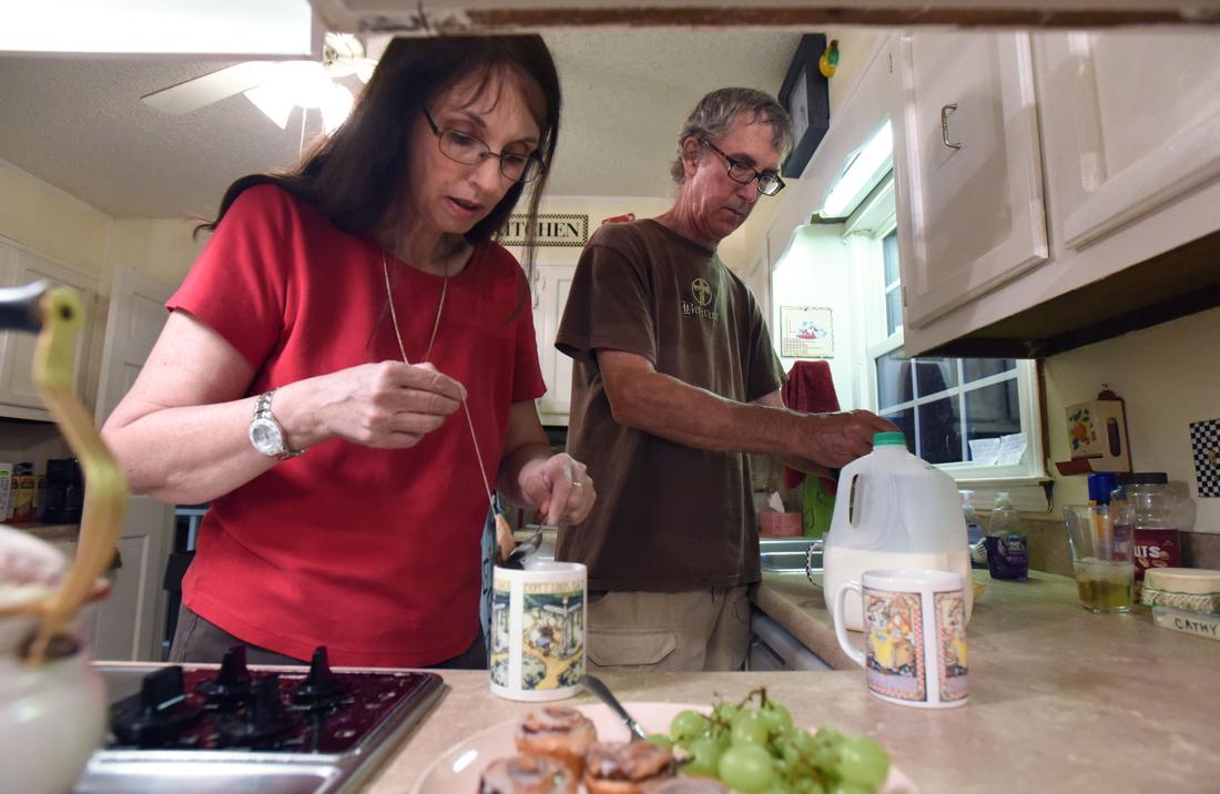 Cathy Palmer and her husband Tim Palmer brew tea at their home in Stone Mountain on Tuesday, June 9, 2015.  HYOSUB SHIN / HSHIN@AJC.COM