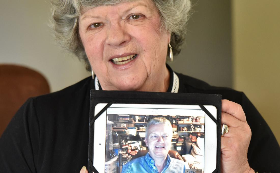 Maureen holds a screen capture from a recent Skype conversation she had with her brother, Chris Miles, who lives in Dorset, England. Hyosub Shin, hshin@ajc.com