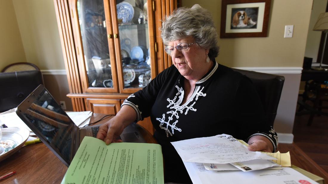 In her Fayetteville home, Maureen Miles shuffles through the documents she gathered trying to find her brother Chris Miles, who lives in England. The didn't know each other existed until late last year.   Hyosub Shin, hshin@ajc.com