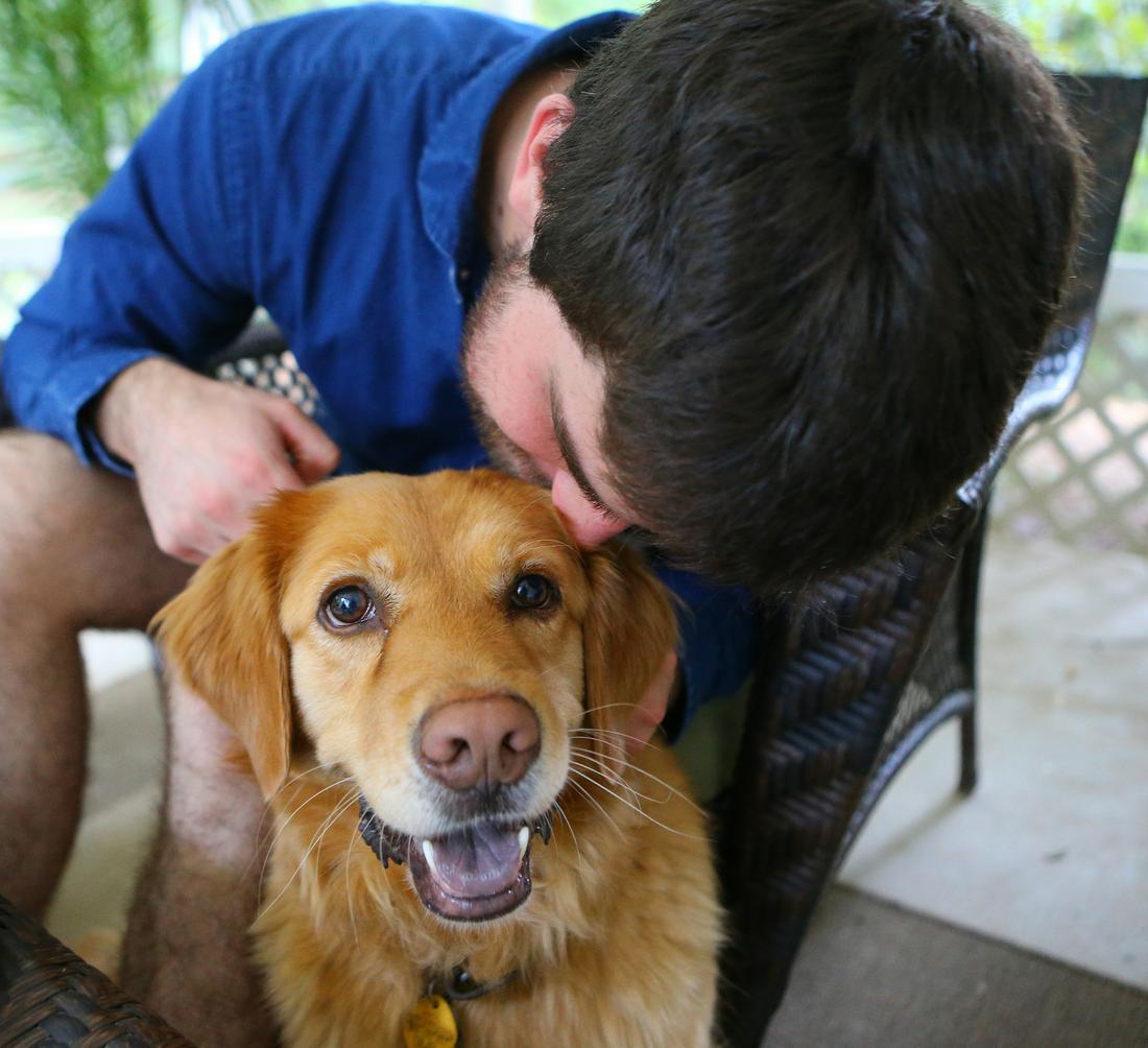 Josh with the family dog Lilly. Photo: Curtis Compton / ccompton@ajc.com
