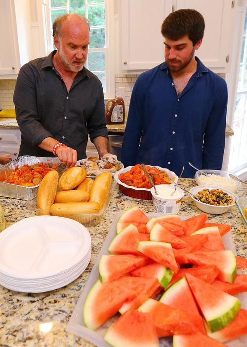 Jeff and Josh get ready to share a Sunday evening family meal at the Schultz home in Johns Creek. Photo: Curtis Compton / ccompton@ajc.com