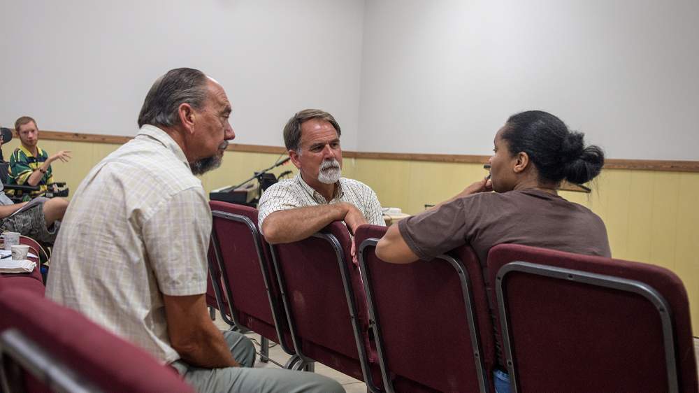 Murray (center), pastor of Grace Baptist Church at DaySpring Farms, meets with members of his congregation after Sunday service.