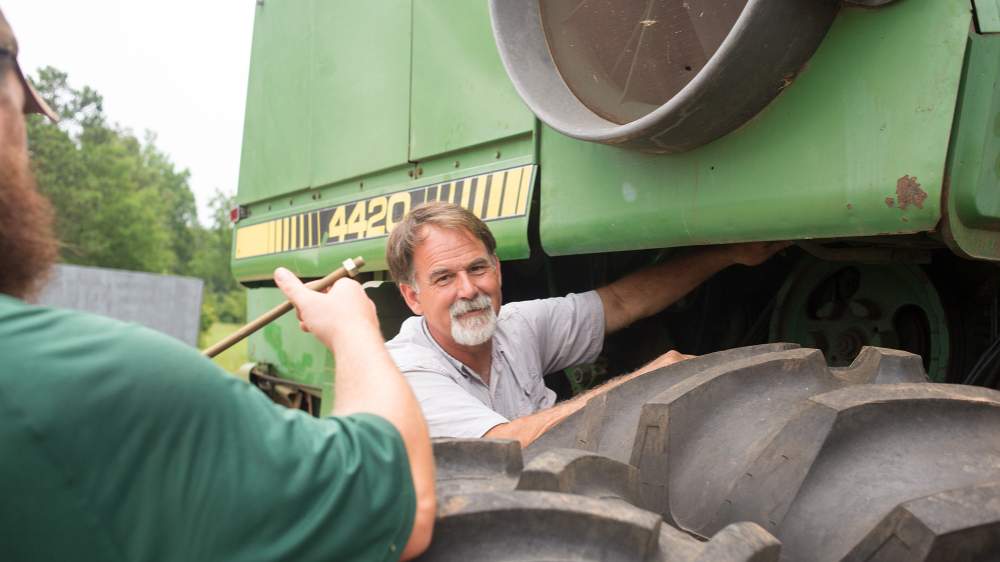 Nathan’s father, Murray Brett, works on the combine harvester used to bring in the wheat crop.