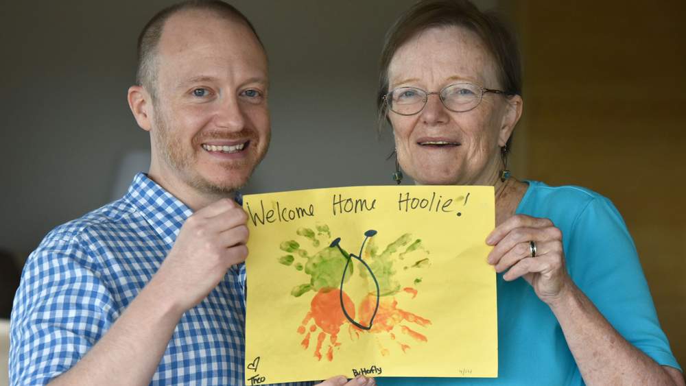 Anne and her son Brooks hold the welcome sign her grandson drew to welcome Marty home. Hyosub Shin